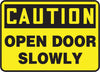 Accuform Signs MABR607VS  10'' X 14'' Black And Yellow 4 mils Adhesive Vinyl Admittance And Exit Sign ''CAUTION OPEN DOOR SLOWLY'' (1/EA)
